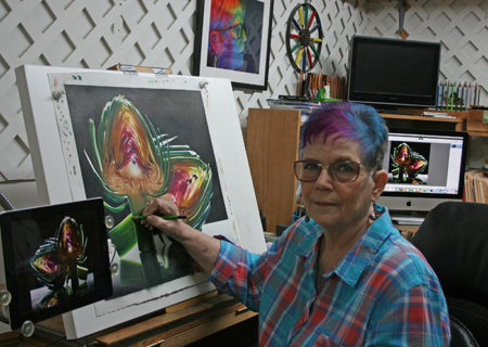 Cecile Baird standing with her artwork Secret Heart
